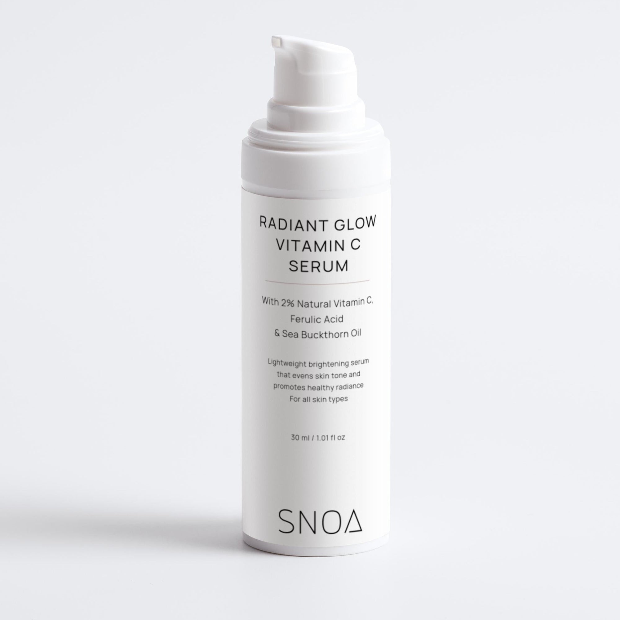 White skincare serum bottle labeled 'Radiant Glow Vitamin C Serum' by SNOA on a light gray background