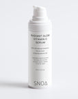 White skincare serum bottle labeled 'Radiant Glow Vitamin C Serum' by SNOA on a light gray background