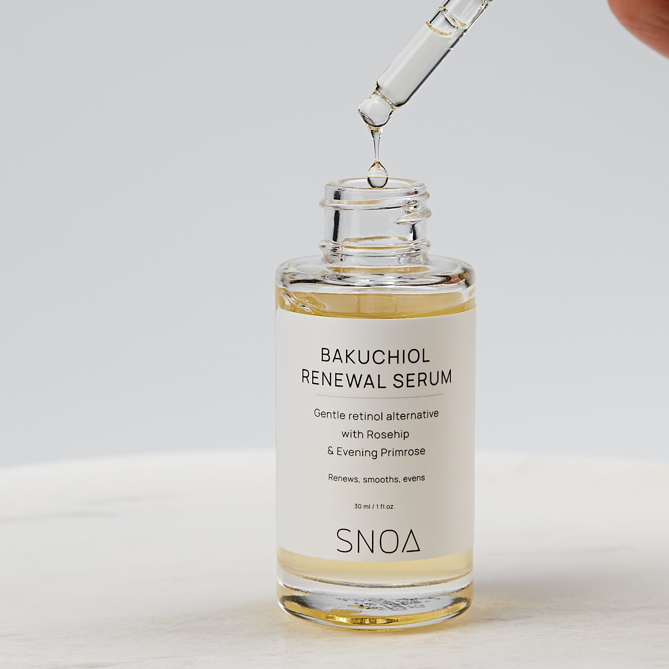 Bakuchiol renewal serum with dropper on a light background