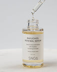 Bakuchiol renewal serum with dropper on a light background