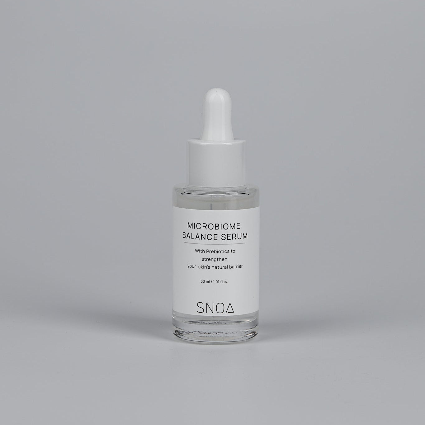 SNOA Microbiome Balance Serum bottle on a gray background