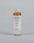 SNOA dual-phase makeup remover bottle on a gray background