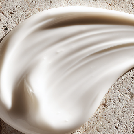 White cream smear on a textured beige surface